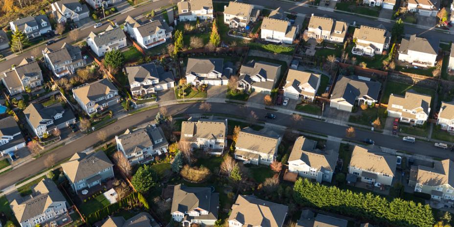 Aerial view of a neighborhood consisting of single and multifamily homes.